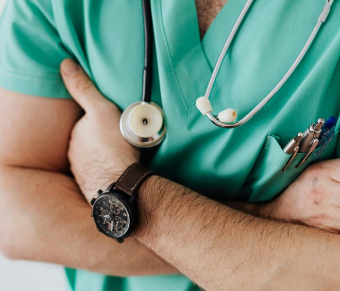 pexels-photo-4021779-4021779 Doctor in scrubs with folded arms and stethoscope, symbolizing confidence in healthcare.